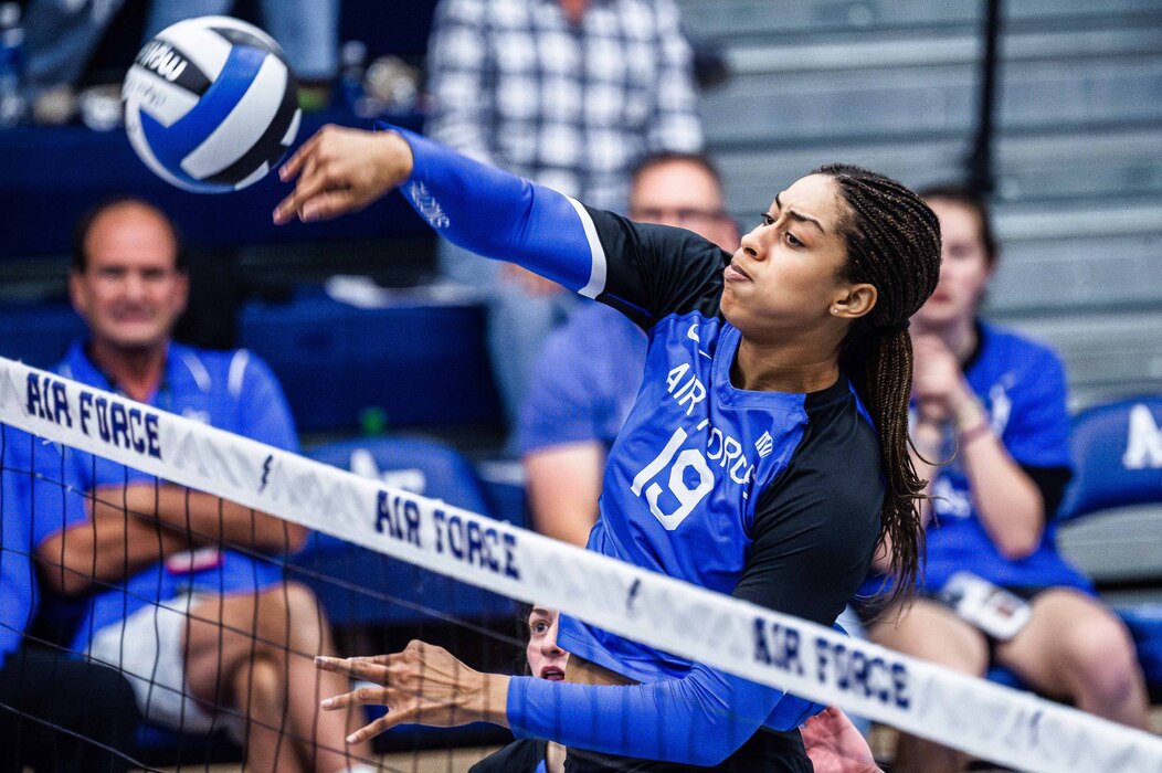 Air Force’s Joi Harvey swings through for a kill during the Falcons’ conference volleyball game