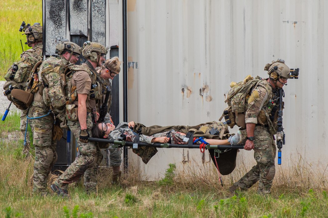 Airmen assigned to the 38th Rescue Squadron carry simulated victims to a safe zone