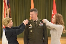 Brig. Gen. Howard was promoted to his current rank in a ceremony at the Eisenhower Conference and Catering center on Fort Eisenhower January 5, 2024. Pinning his star is his wife Lisa, left, and his daughter Madeline.