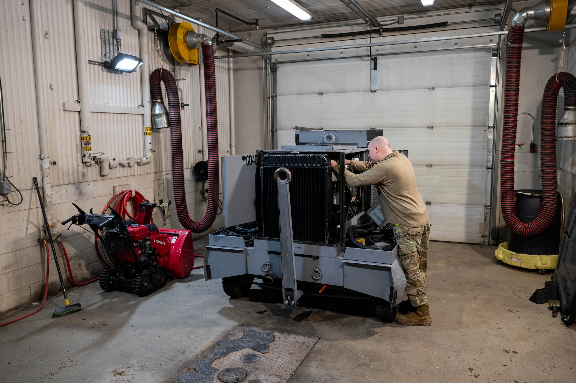 An Airman working on a power generator