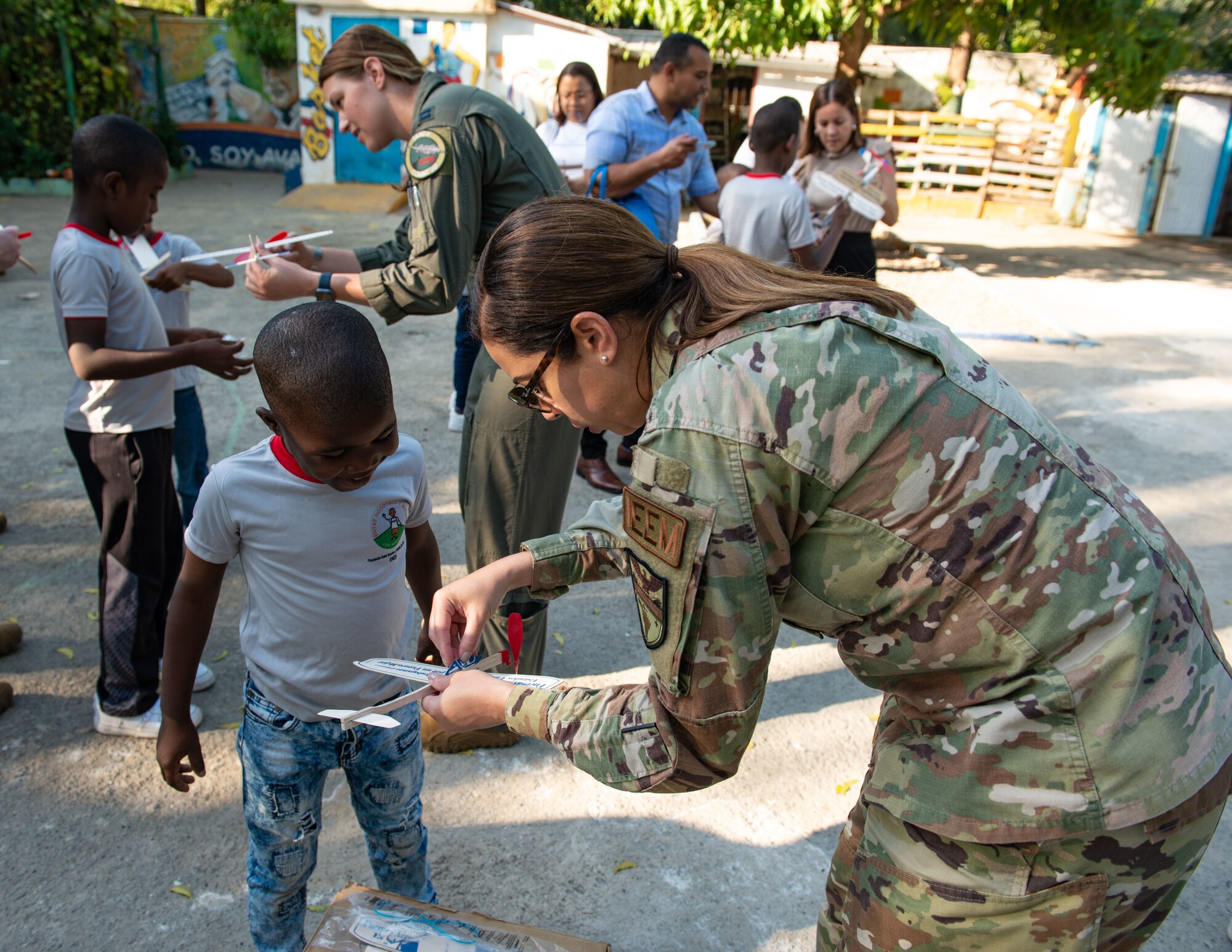 Senior Master Sgt. Keyla Watt, 12th Air Force International Enlisted Affairs Manager, helps a young boy build his toy airplane at Fundación Ened Boca Chica, Dominican Republic, Feb. 21, 2023. The foundation is an orphanage that hosts 28 boys between 5-16 years old who are from both Dominican and Haitian descent. Members from the U.S. Air Force and Fuerza Aérea de Republica Dominicana visited the orphanage to talk about their profession and the importance of education and resilience. (U.S. Air Force photo by Tech. Sgt. Jessica H. Smith-McMahan)