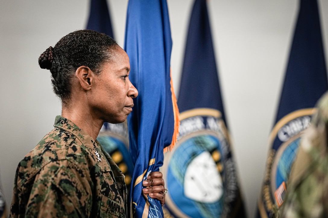 U.S. Marine Corp Maj. Gen. Lorna Mahlock holds the guidon after receiving command.