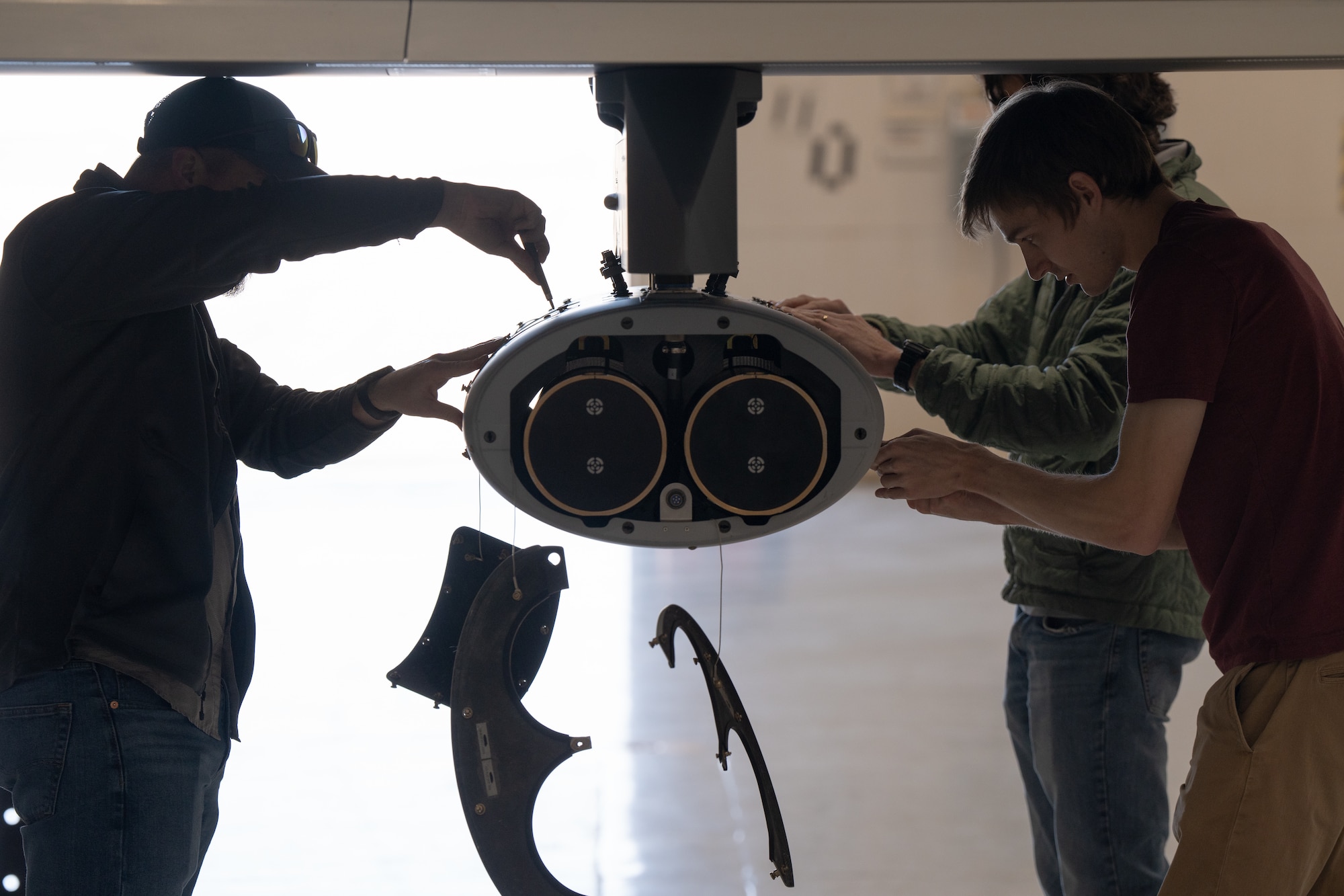 Altius employees perform pre-flight checks on a dual launch pod attached to an MQ-9 Reaper before an Airborne Adaptive Enterprise (A2E) demonstration at Cannon Air Force Base, N.M., Nov. 28, 2023. Adaptive Airborne Enterprise will utilize large and small uncrewed aircraft systems at scale, including a mix of attritable and expendable systems with modular payloads. (U.S. Air Force photo by Staff Sgt. Nicholas Swift)