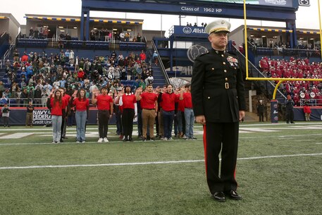 U.S. Marine Corps Brig. Gen. Jim Wellons, the assistant deputy commandant for Programs, Programs and Resources, leads a formation of future Marines as they take the oath of enlistment during the 2023 Military Bowl at Navy-Marine Corps Stadium in Annapolis, Maryland, Dec. 27, 2023.