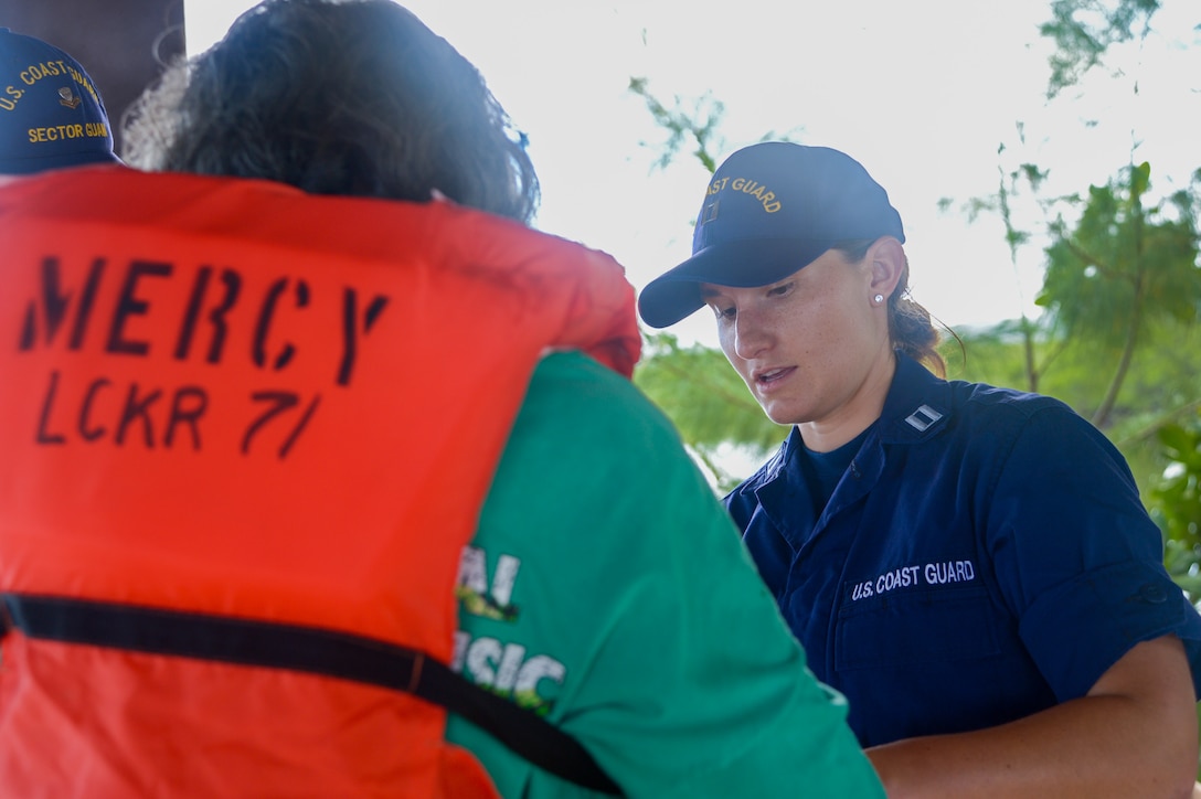 U.S. Coast Guard Lt. Anna Maria Vaccaro, from Niceville, Florida, helps a local Palauan resident don a Type 1 personal flotation device during a boat safety class in Melekeok, Palau, as part of Pacific Partnership 2024-1, Dec. 28, 2023. Pacific Partnership, now in its 19th iteration, is the largest multinational humanitarian assistance and disaster relief preparedness mission conducted in the Indo-Pacific and works to enhance regional interoperability and disaster response capabilities, increase security stability in the region, and foster new and enduring friendships. (U.S. Navy photo by Mass Communication Specialist 2nd Class Jacob Woitzel)