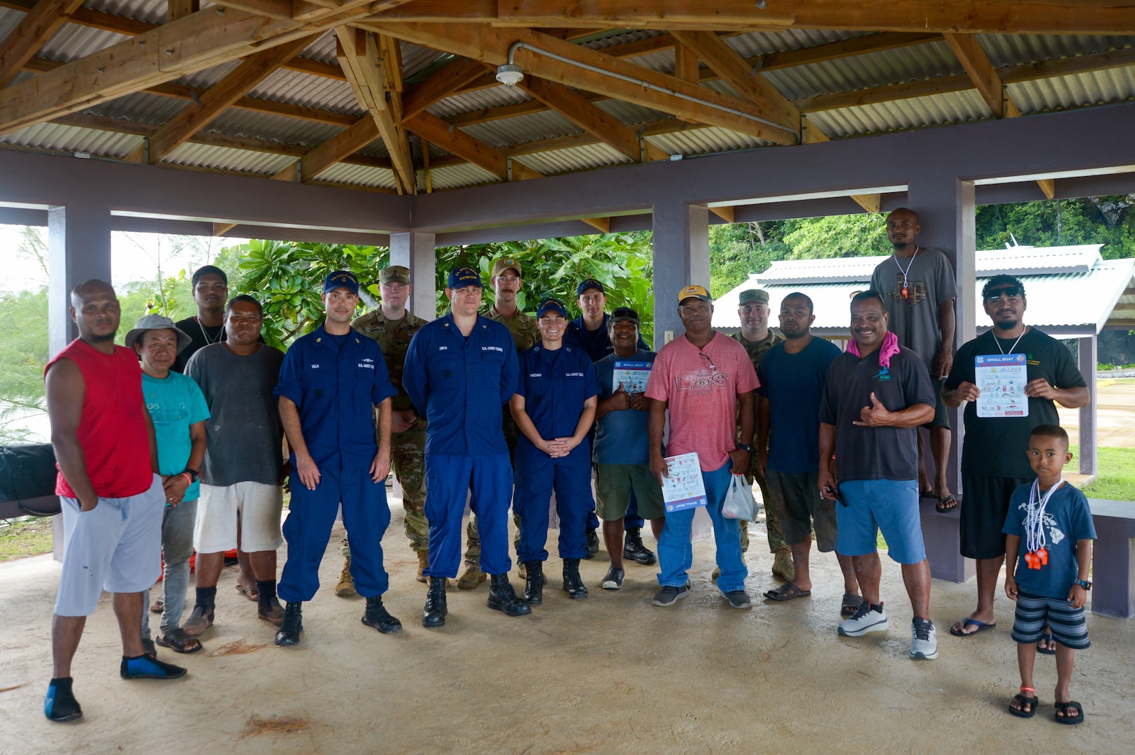 A U.S. Navy Sailor, U.S. Coast Guardsmen,  U.S. Army soldiers, and local Palauan residents pose for a photo during a boat safety class in Melekeok, Palau, as part of Pacific Partnership 2024-1, Dec. 28, 2023. Pacific Partnership, now in its 19th iteration, is the largest multinational humanitarian assistance and disaster relief preparedness mission conducted in the Indo-Pacific and works to enhance regional interoperability and disaster response capabilities, increase security stability in the region, and foster new and enduring friendships. (U.S. Navy photo by Mass Communication Specialist 2nd Class Jacob Woitzel)