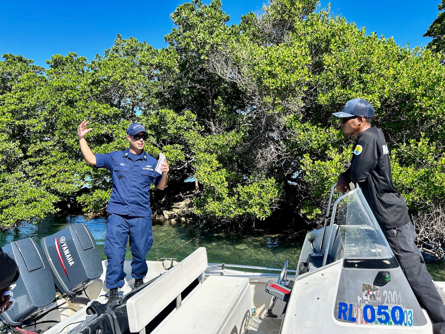 Petty Officer 1st Class Joel Vela discusses boating operations with Palau Rangers during a boating safety class on Dec. 27, 2023. The U.S. Coast Guard regularly works with partners in the Republic of Palau; this series of events was part of Pacific Partnership 2024, which is now, in its 19th iteration, the largest multinational humanitarian assistance and disaster relief preparedness mission conducted in the region. (U.S. Coast Guard photo)