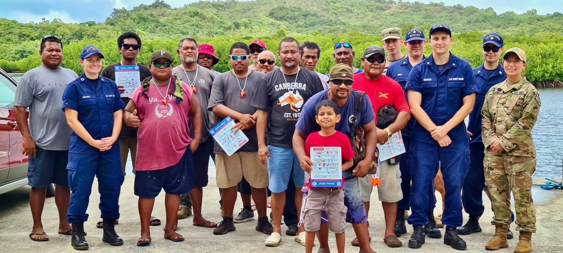 U.S. Coast Guard and U.S. Navy members stand for a photo with community members in the Republic of Palau following a boating safety class on Dec. 27, 2023. The U.S. Coast Guard regularly works with partners in the Republic of Palau; this series of events was part of Pacific Partnership 2024, which is now, in its 19th iteration, the largest multinational humanitarian assistance and disaster relief preparedness mission conducted in the region. (U.S. Coast Guard photo)