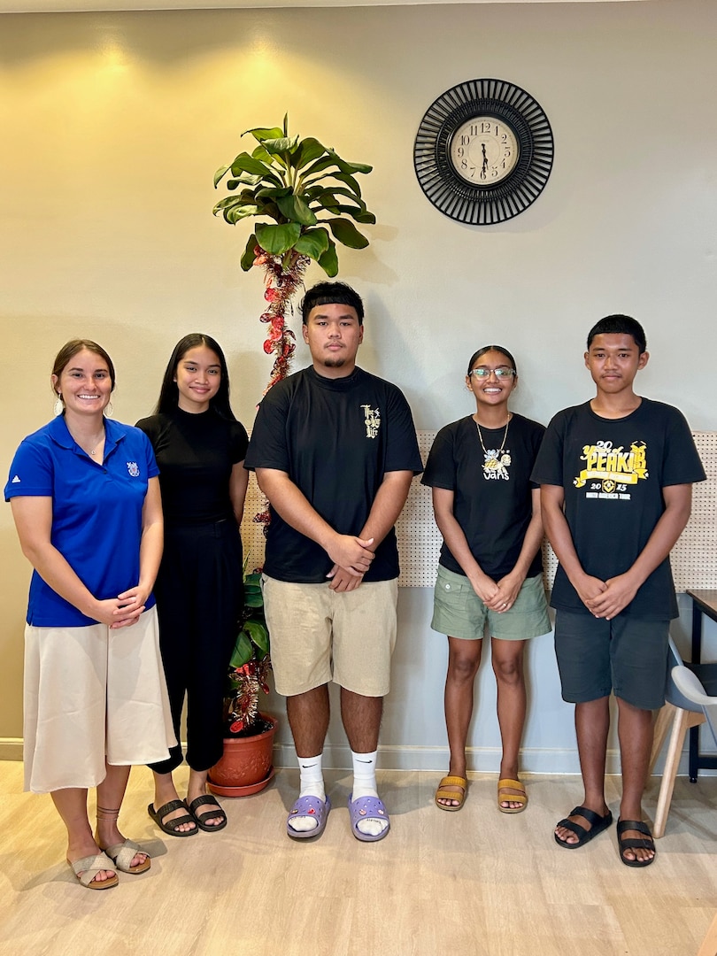 Lt. Anna Maria Vaccaro stands for a photo with Palauan high school seniors after discussing U.S. Coast Guard Academy life and application processes in the Republic of Palau on Dec. 29, 2023. The U.S. Coast Guard regularly works with partners in the Republic of Palau; this series of events was part of Pacific Partnership 2024, which is now, in its 19th iteration, the largest multinational humanitarian assistance and disaster relief preparedness mission conducted in the region. (U.S. Coast Guard photo)