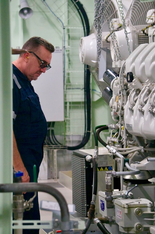 U.S. Coast Guard inspector Brad Schoenwald from the U.S. Coast Guard Cruise Ship National Center of Expertise looks at mechanical spaces during a Certificate of Compliance (COC) exam on the 1,036-foot Maltese-flagged cruise ship MSC Bellissima on its first-ever U.S. port call at the Port of Guam, on Jan. 3, 2024. The U.S. Coast Guard conducts COC exams for new or existing vessels that are embarking passengers from a U.S. port for the first time, carrying U.S. citizens as passengers with initial port calls at U.S. ports, or have undergone significant modifications or alterations including changes that affect structural fire protection or means of egress, in order to ensure these vessels, meet required safety and regulatory standards. (U.S. Coast Guard photo by Josiah Moss)