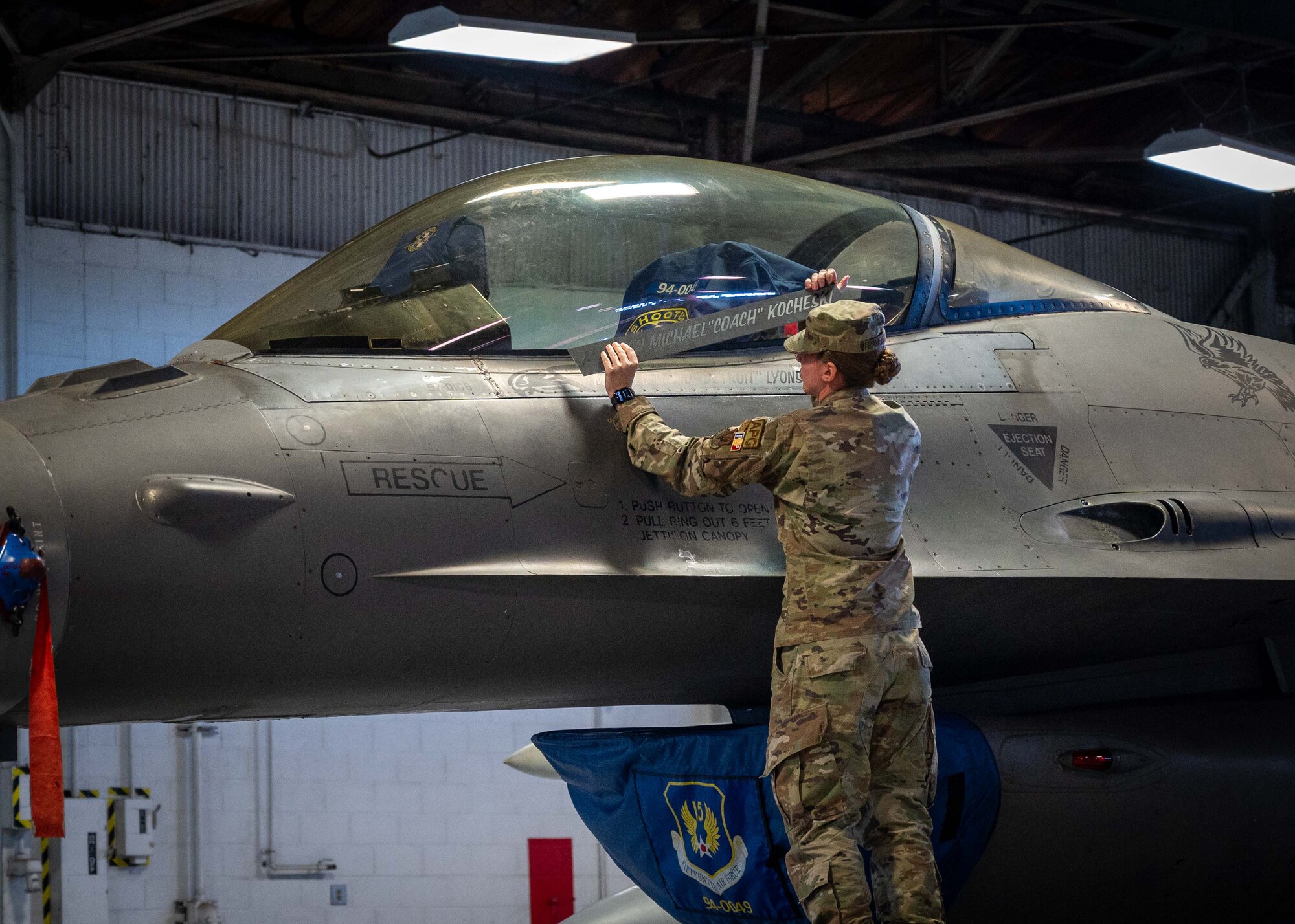 U.S. Air Force Staff Sgt. Jennifer Ramsbacher, assistant dedicated crew chief 20th Aircraft Maintenance Squadron, unveils Maj Gen David B. Lyons name on the Fifteenth Air Force F-16 Fighting Falcon during a change of command ceremony Jan. 5 at Shaw Air Force Base, South Carolina.