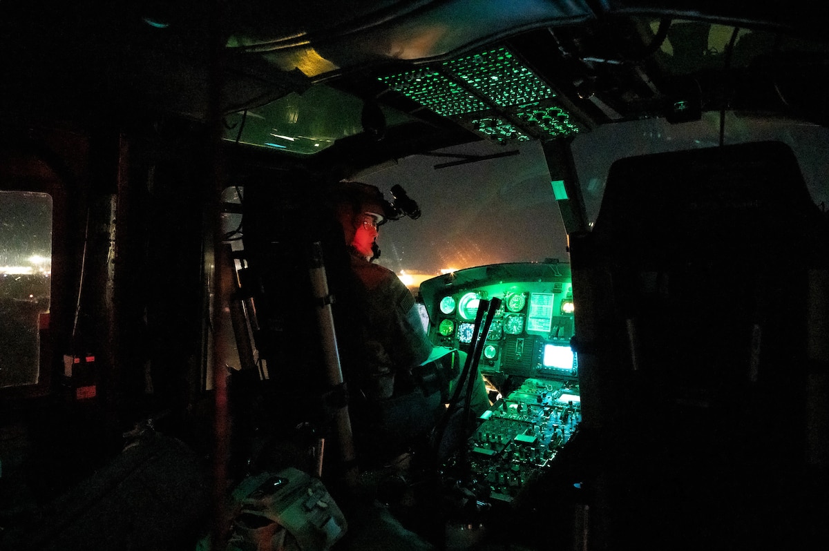 An Airman in a cockpit of a UH-1 Huey.