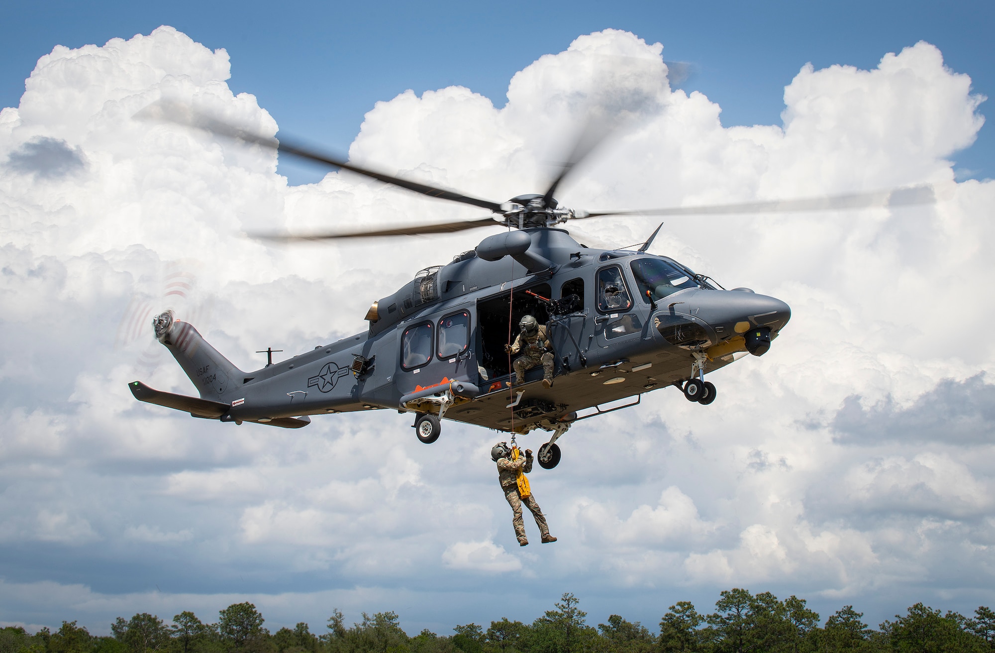 An MH-139A Grey Wolf lifts an Air Force Global Strike Command Detachment 7 special mission aviator into the air