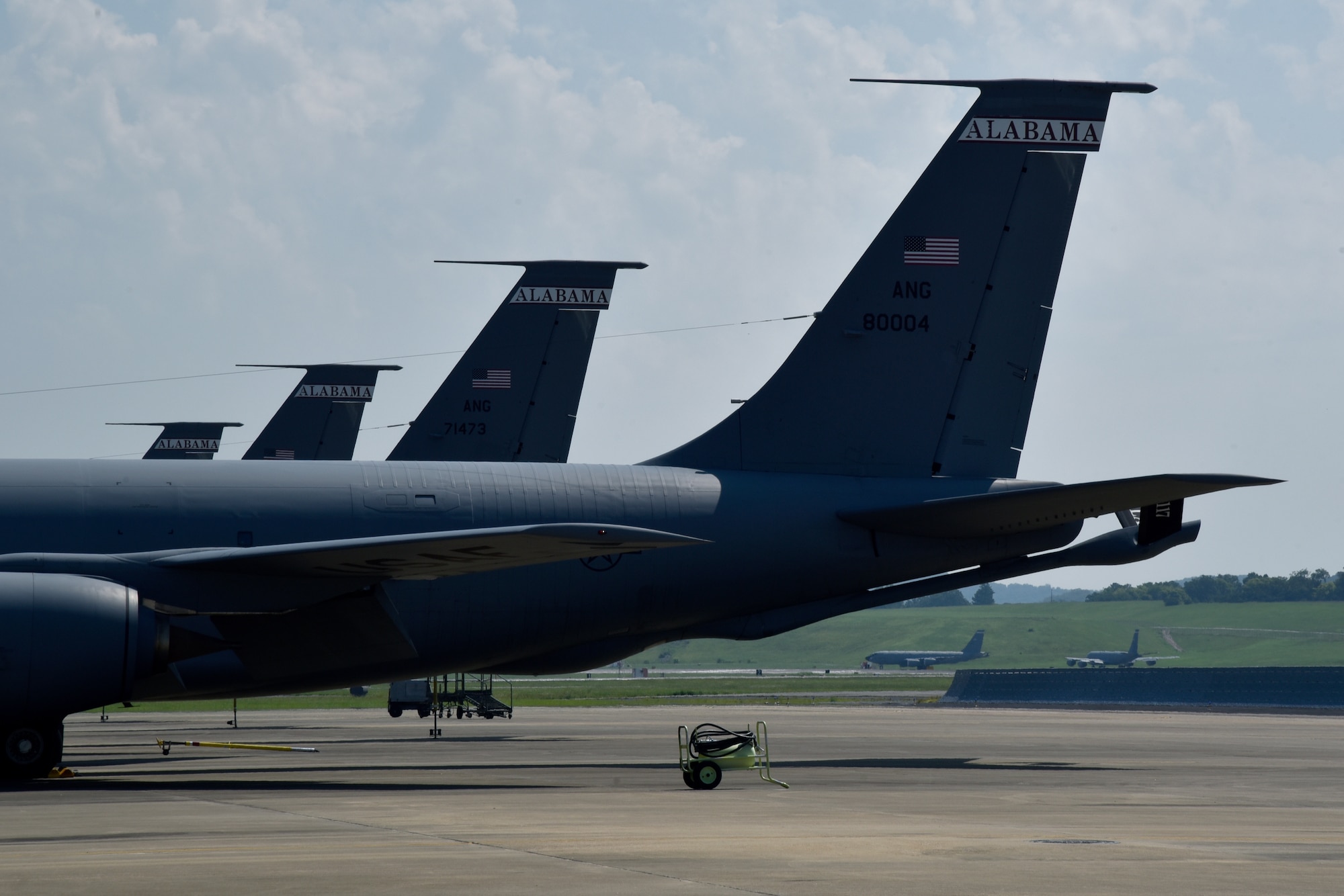 Multiple U.S. Air Force KC-135 Stratotanker belonging to the 117th Air Refueling Wing sit parked on the flightline while two prepare to take off in the background of Sumpter Smith Joint National Guard Base, Alabama, August 6, 2023. The 117 ARW’s mission is to provide quality worldwide air refueling, airlift, support, logistics, intelligence, and medical services in support of the greater Birmingham community, the state of Alabama, and the nation.(U.S. Air National Guard photo by Staff Sgt. Shelby Thurman)