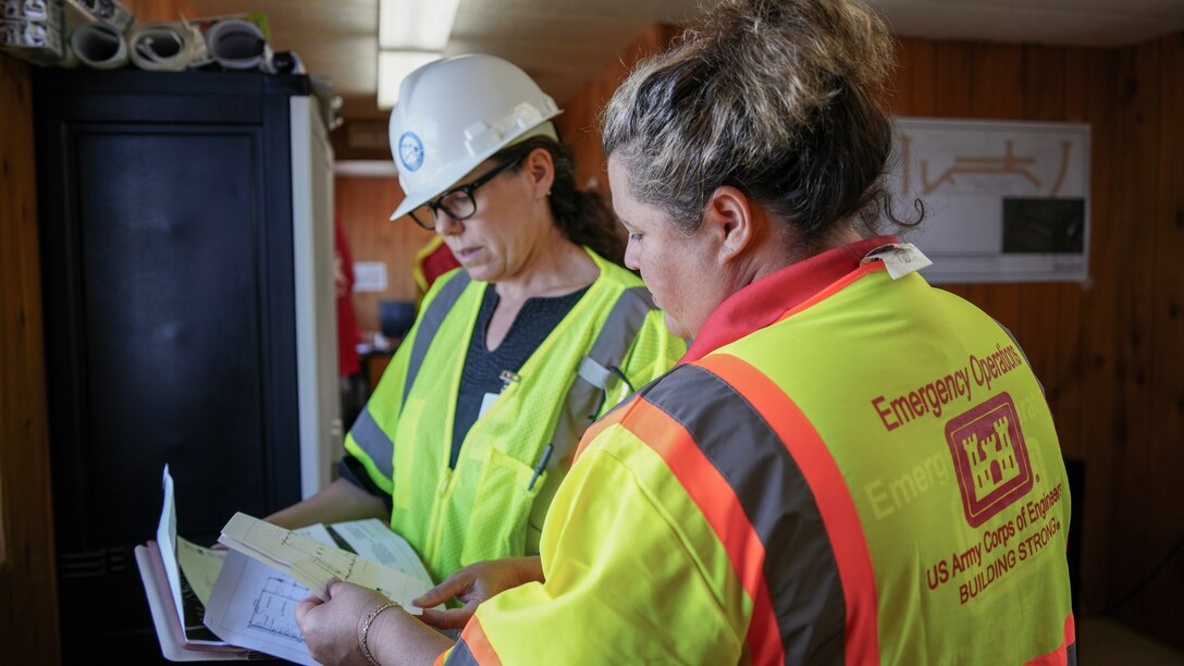 U.S. Army Corps of Engineers Critical Public Facilities Mission Manager Kara Vick speaks with Hawaii Department of Education Engineer Laura Wahmann Jan. 4, 2024 in Lahaina, Hawaii.
