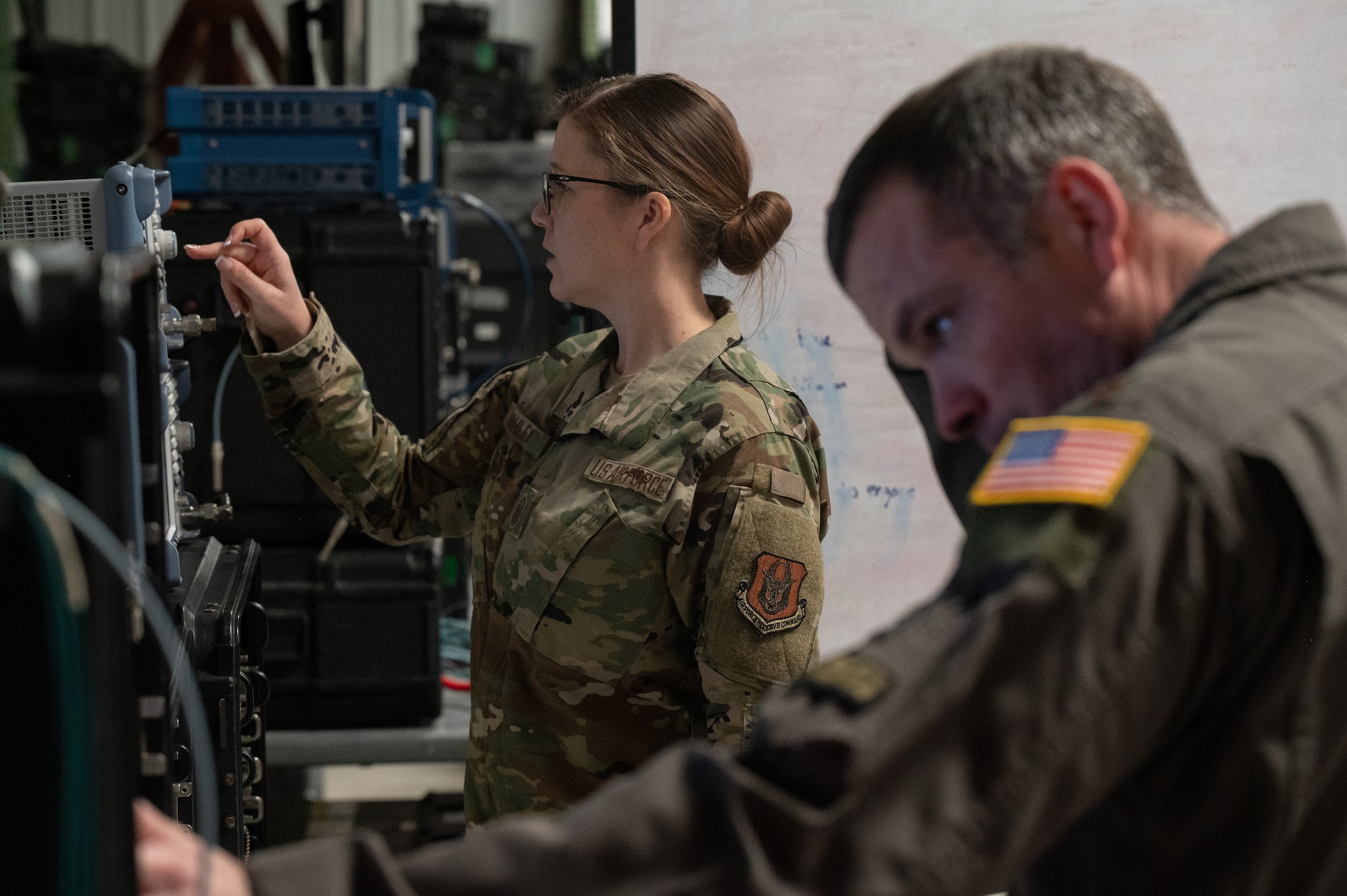 Two people in military uniforms in  warehouse