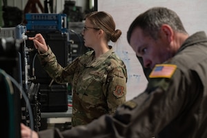 Two people in military uniforms in  warehouse