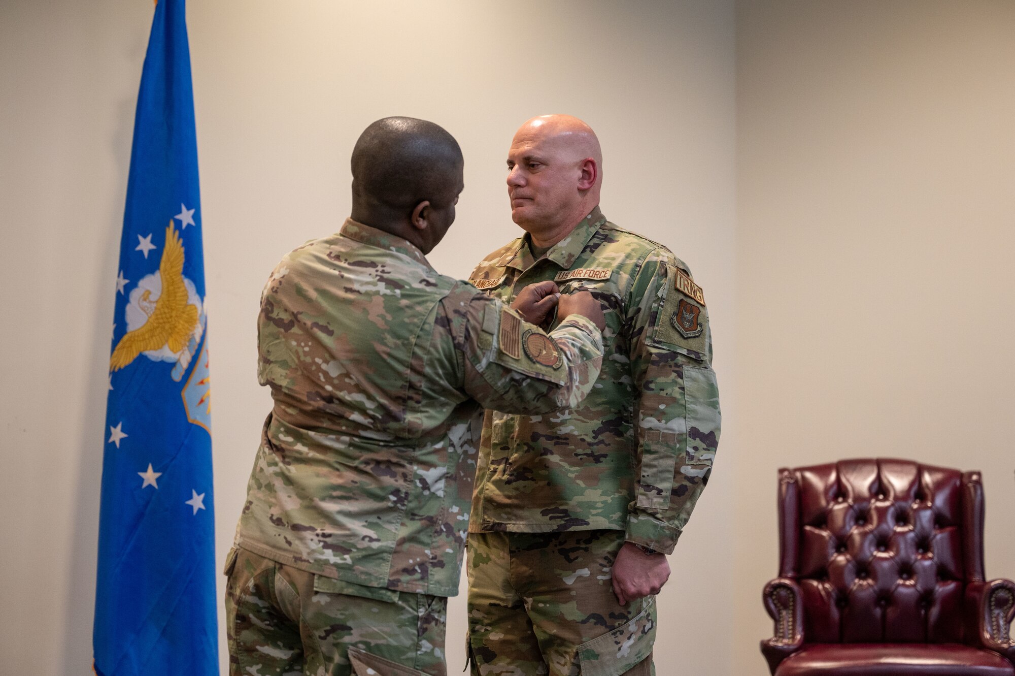 Maj Fountain attaches a medal to Senior Blanchard's collar