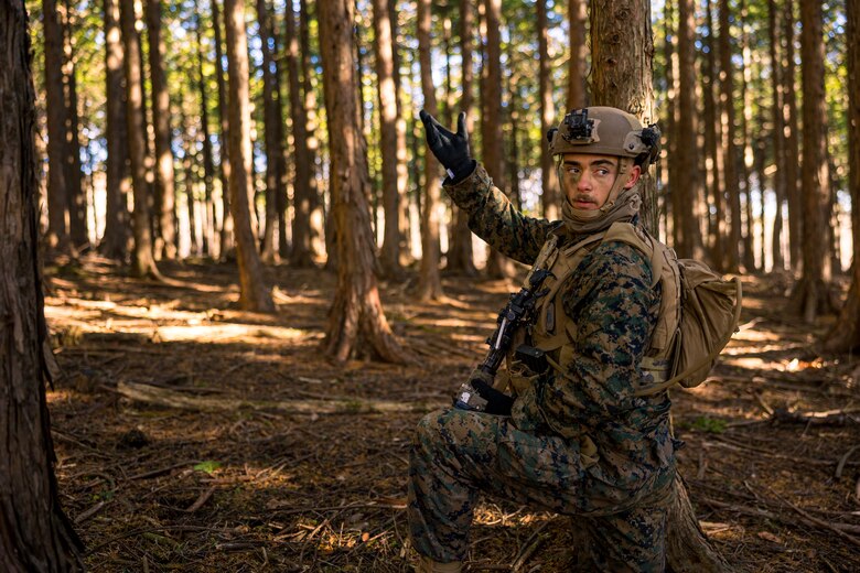 U.S. Marine Corps Cpl. Alexander Crider signals to his squad during Stand-in Force Exercise 24 at Combined Arms Training Center Camp Fuji, Japan, Dec. 4, 2023. SIFEX 24 is a division-level exercise involving all elements of the Marine Air-Ground Task Force focused on strengthening multi-domain awareness, maneuver, and fires across a distributed maritime environment. This exercise serves as a rehearsal for rapidly projecting combat power in defense of allies and partners in the region. Crider, a native of Florence, Colorado and is a rifleman with 2d Battalion, 7th Marine Regiment. 2/7 is forward deployed in the Indo-Pacific under 4th Marine Regiment, 3d Marine Division as part of the Unit Deployment Program. (U.S. Marine Corps photo by Lance Cpl. Matthew Morales)