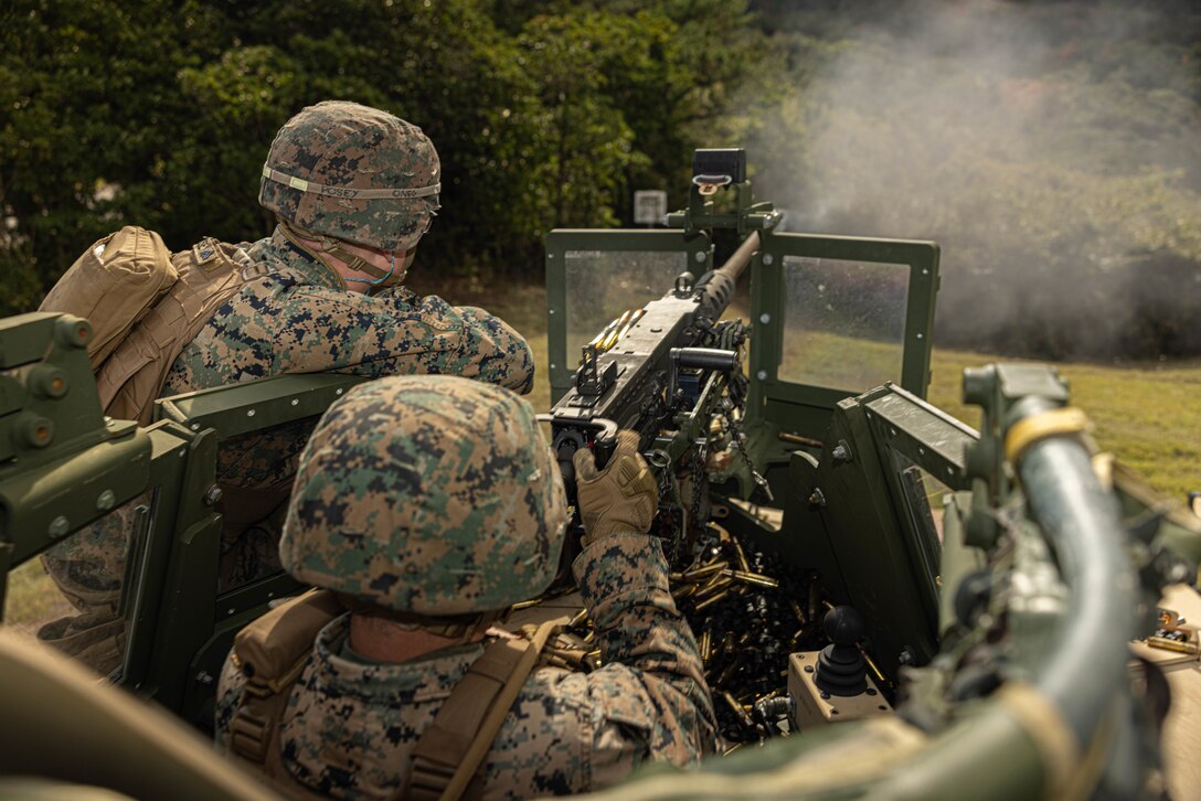 U.S. Marine Corps Cpl. Zachary Posey, left a heavy equipment mechanic, and Cpl. Jacob Benton, right, an automotive maintenance technician, both with 3rd Maintenance Battalion, 3rd Marine Logistics Group, fire a M2 Browning .50 Caliber machine gun at Camp Hansen, Okinawa, Japan, Dec. 22, 2023. The reason for the training was to increase their lethality, survivability, and capability when it comes to employing the M2 .50 Caliber machine gun in a mounted platform. (U.S. Marine Corps photo by Lance Cpl. Weston Brown)