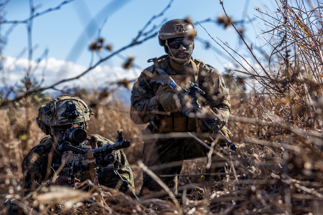 U.S. Marine Corps Lance Cpl. Zabdiel Echie, left, and Cpl. Kendall Hill, right, both machine gunners with 2nd Battalion, 7th Marine Regiment, post security for a notional casualty evacuation drill during Stand-in Force Exercise 24 at the Eastern Fuji Maneuver Area on Combined Arms Training Center Camp Fuji, Dec. 3, 2023. SIFEX 24 is a division-level exercise involving all elements of the Marine Air-Ground Task Force focused on strengthening multi-domain awareness, maneuver, and fires across a distributed maritime environment. This exercise serves as a rehearsal for rapidly projecting combat power in defense of allies and partners in the region. (U.S. Marine Corps photo by Cpl. Paley Fenner)