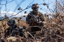 U.S. Marine Corps Lance Cpl. Zabdiel Echie, left, and Cpl. Kendall Hill, right, both machine gunners with 2nd Battalion, 7th Marine Regiment, post security for a notional casualty evacuation drill during Stand-in Force Exercise 24 at the Eastern Fuji Maneuver Area on Combined Arms Training Center Camp Fuji, Dec. 3, 2023. SIFEX 24 is a division-level exercise involving all elements of the Marine Air-Ground Task Force focused on strengthening multi-domain awareness, maneuver, and fires across a distributed maritime environment. This exercise serves as a rehearsal for rapidly projecting combat power in defense of allies and partners in the region. (U.S. Marine Corps photo by Cpl. Paley Fenner)