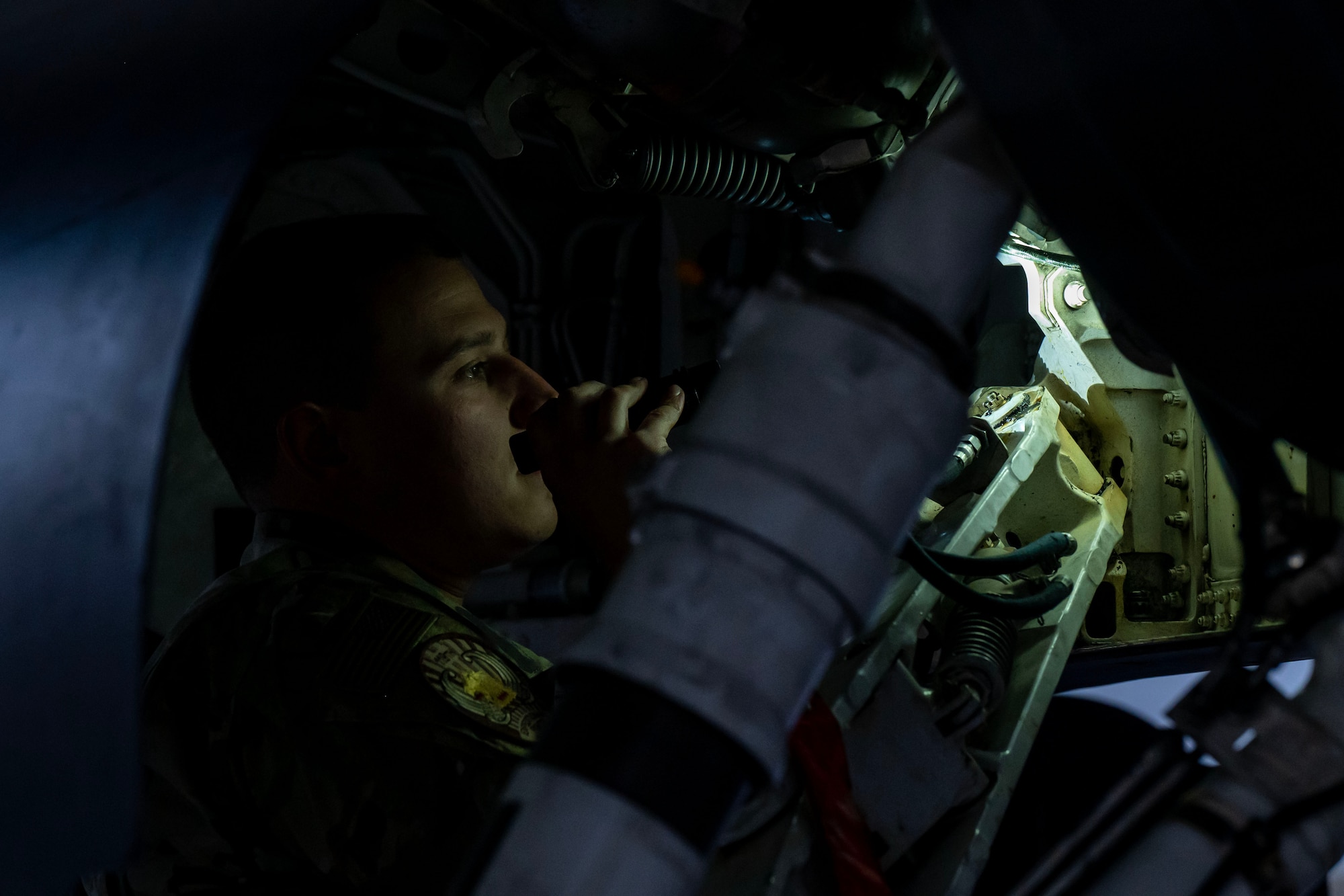 Airman 1st Class Jake Brodbeck, an F-16 crew chief, inspects a U.S. Air Force F-16 Fighting Falcon at an undisclosed location in the U.S. Central Command area of responsibility as part of Exercise Ballast Cannon, Jan. 6, 2024.