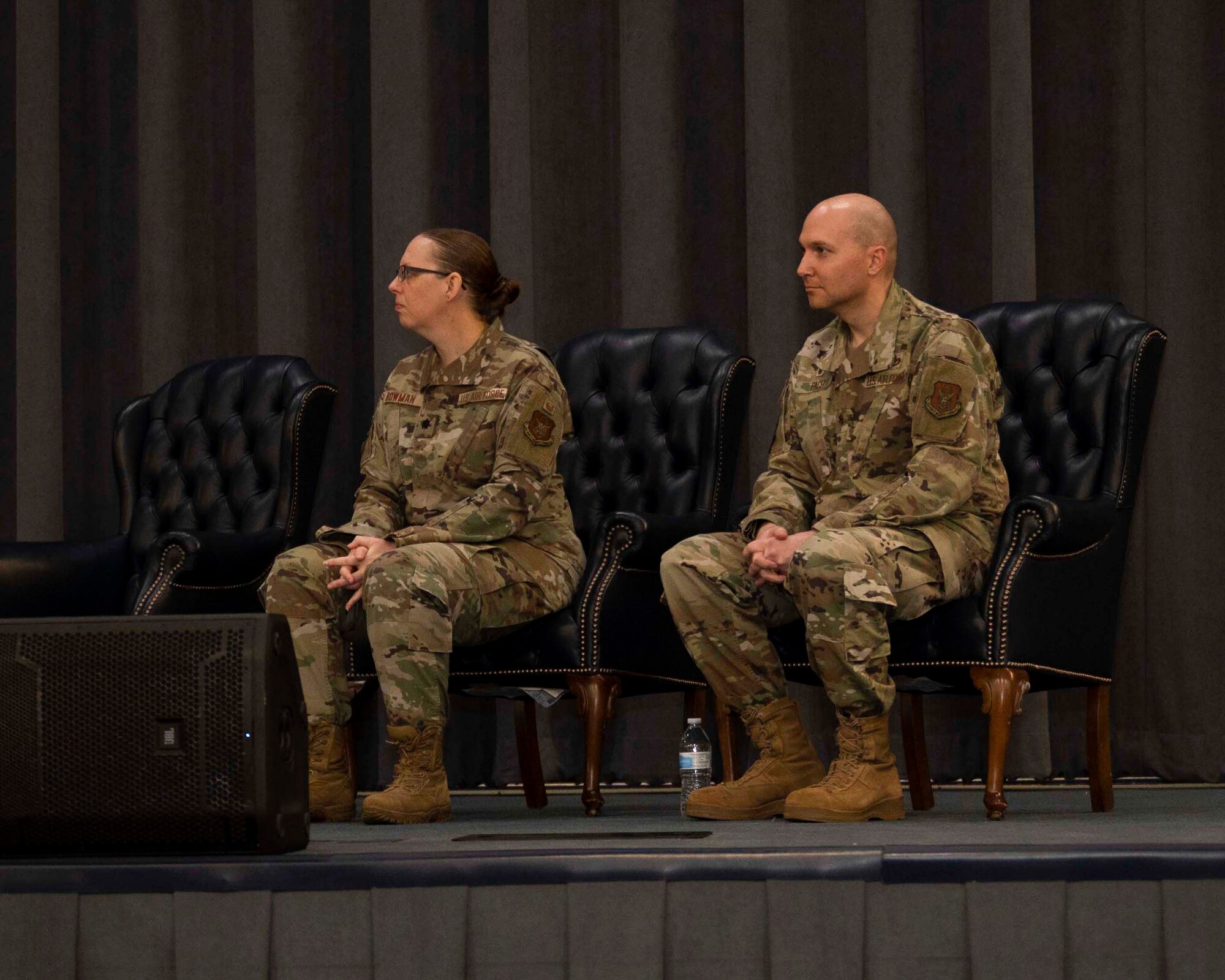 Photo of Airman sitting in chairs on stage