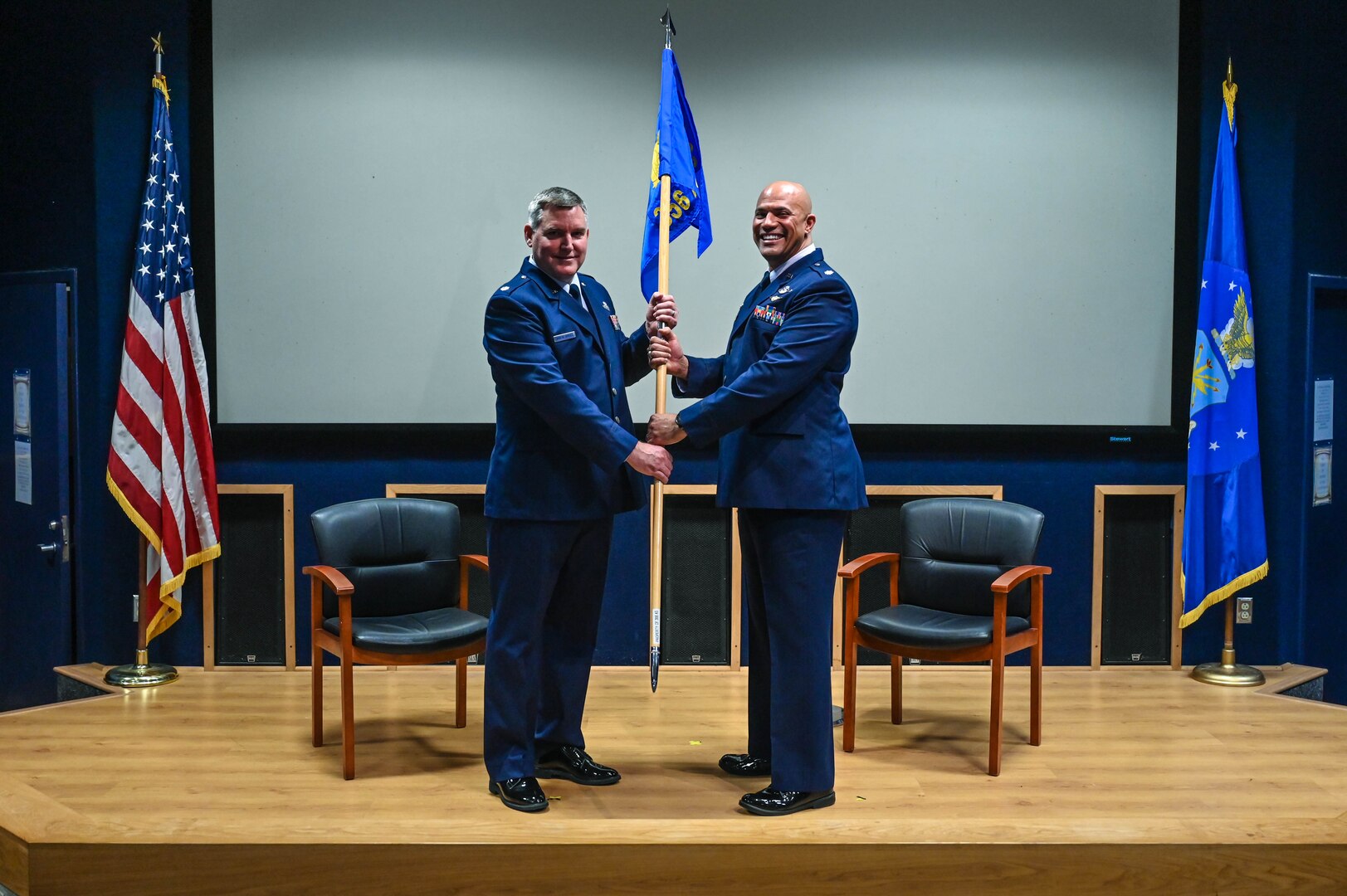 Lt. Col. Matthew Vandewalle, 433rd Operations Group commander, hands the 356th Airlift Squadron guidon to the unit’s new commander, Lt. Col. Christopher Jones, as part of an assumption of command ceremony at Joint Base San Antonio-Lackland, Texas on Jan. 5th, 2024.