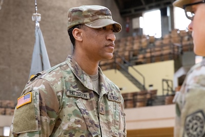 Capt. Cameron Ward, the 1863rd’s Commander, Maj. Gen. Rodney Boyd, Assistant Adjutant General – Army of the Illinois National Guard and Commander of the Illinois Army National Guard, Sgt. Dejuan Patterson, a military pay chief with the 1863rd and Patterson’s family gathered for a group photo after the mobilization and promotion ceremony at the Northwest Armory in Chicago Jan. 5.