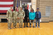 Capt. Cameron Ward, the 1863rd’s Commander, Maj. Gen. Rodney Boyd, Assistant Adjutant General – Army of the Illinois National Guard and Commander of the Illinois Army National Guard, Sgt. Dejuan Patterson, a military pay chief with the 1863rd and Patterson’s family gathered for a group photo after the mobilization and promotion ceremony at the Northwest Armory in Chicago Jan. 5.