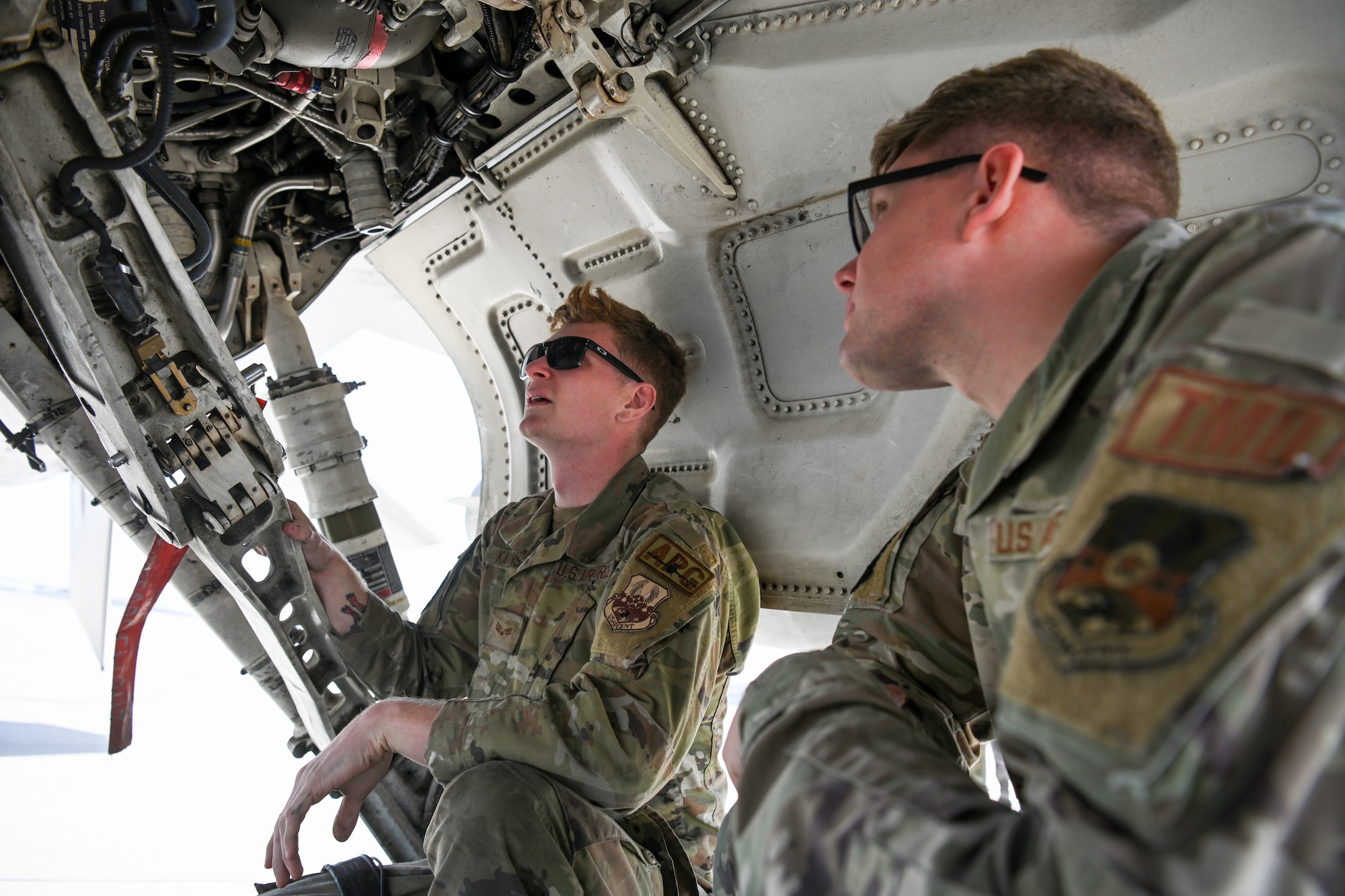 SrA Miller, right, a Traffic Management Craftsman, receives multi-capable Airman training from SrA Kaminski, left, a crew chief, during Exercise Ballast Cannon 24.3.