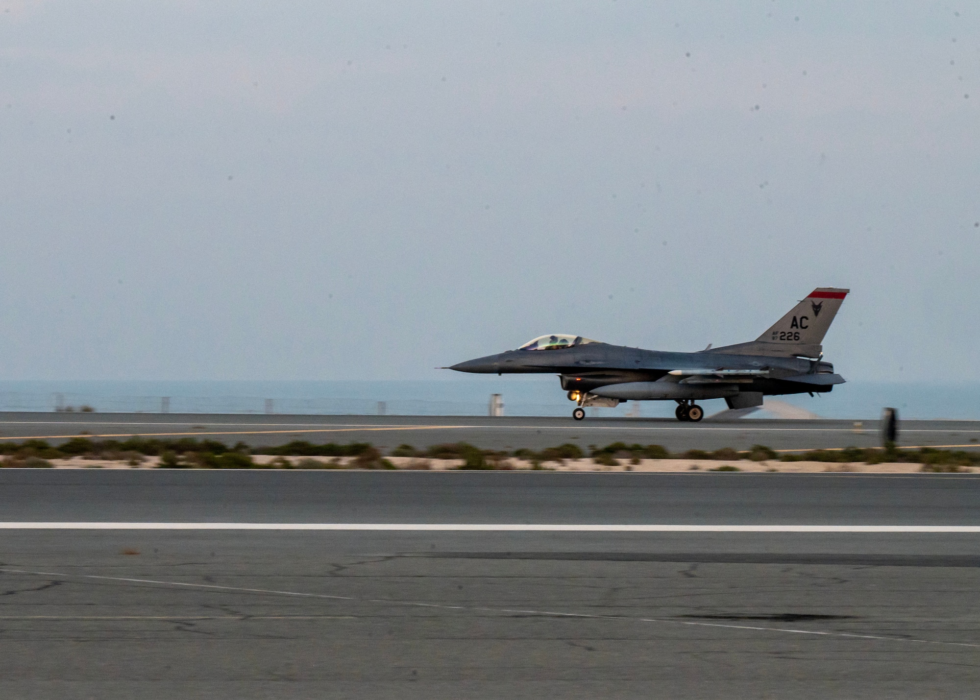 A U.S. Air Force F-16 Fighting Falcon arrives at an undisclosed location in the U.S. Central Command area of responsibility, Jan. 6, 2024. As a routine exercise Ballast Cannon occurs nearly quarterly with the Royal Bahraini Air Force to support the U.S. Air Force’s rapid expeditionary capabilities by integrating Agile Combat Employment objectives for F-16 Fighting Falcon, KC-135 Stratotanker, and operational support personnel.