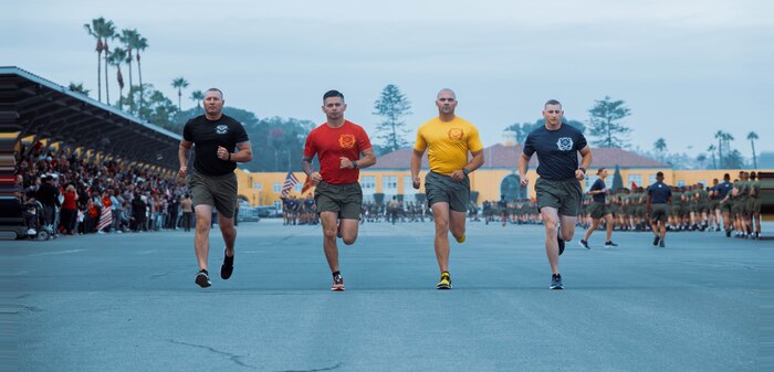 U.S. Marine Corps drill masters with Recruit Training Regiment, lead the motivational run for the new Marines of Lima Company, 3rd Recruit Training Battalion, at Marine Corps Recruit Depot San Diego, Dec. 19, 2023. The motivational run is the last physical training event the Marines will conduct before they graduate from MCRD San Diego. (U.S. Marine Corps photo by Lance Cpl. Janell B. Alvarez)