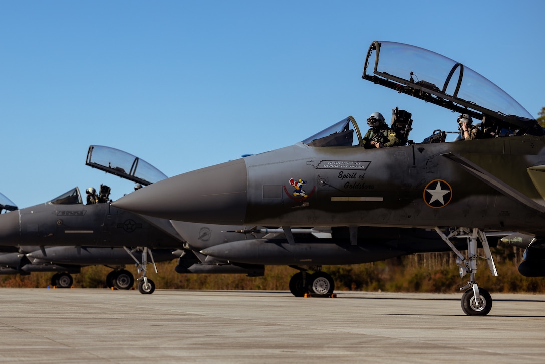 U.S. Airforce F-15E Strike Eagle pilots from the 4th Fighter Wing, Seymour Johnson Air Force Base, prepare to depart from Marine Corps Air Station Cherry Point, North Carolina, Dec. 14, 2023. The aircraft were diverted from Seymour Johnson AFB to MCAS Cherry Point due to airfield maintenance and to refuel. (U.S. Marine Corps photo by Lance Cpl. Matthew Williams)