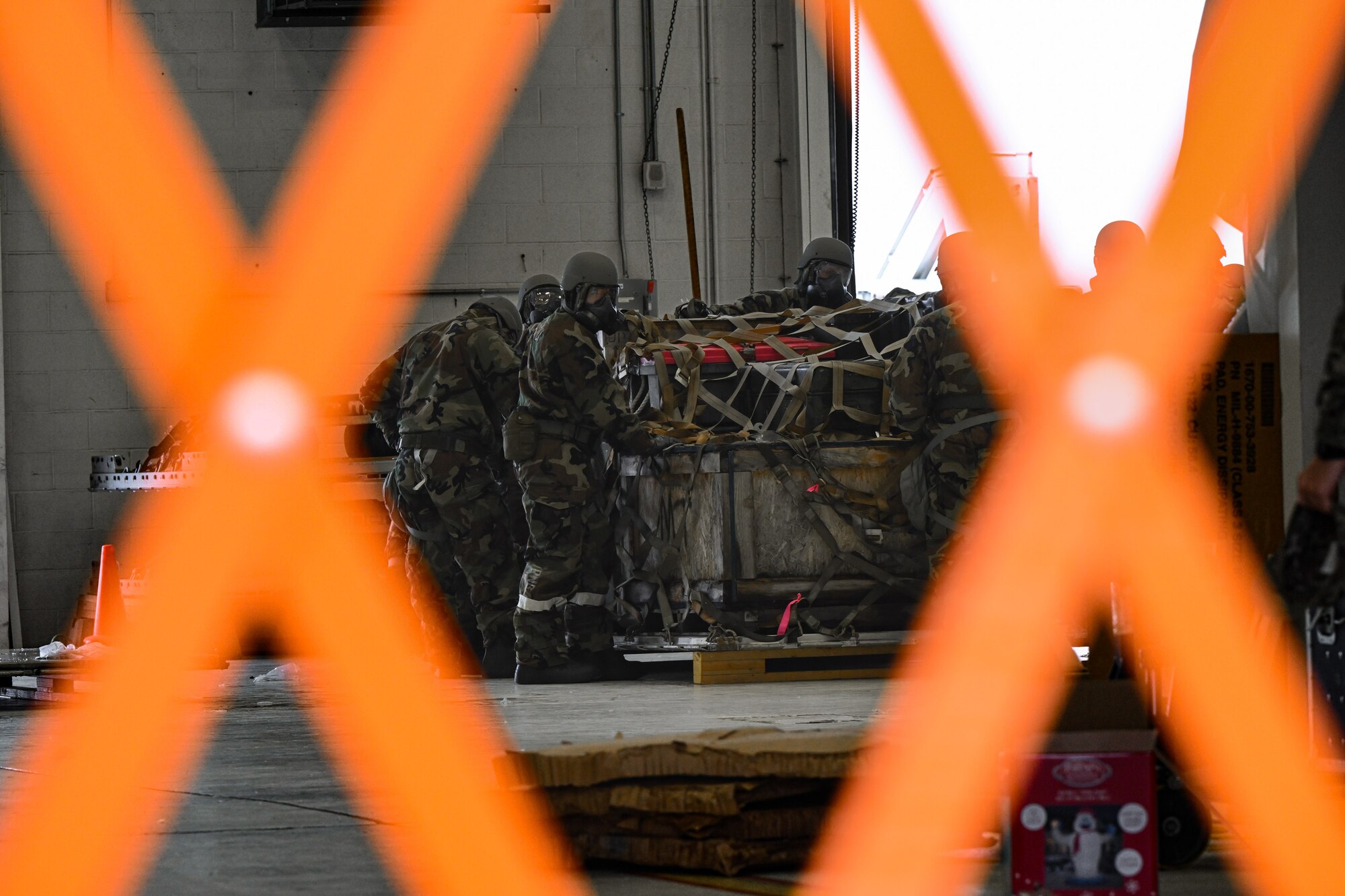 Reserve Citizen Airmen assigned to the 910th Airlift Wing palletize cargo during a Chemical, Biological, Radiological, Nuclear and high-yield Explosives response exercise at Youngstown Air Reserve Station, Ohio, Dec. 3, 2023.
