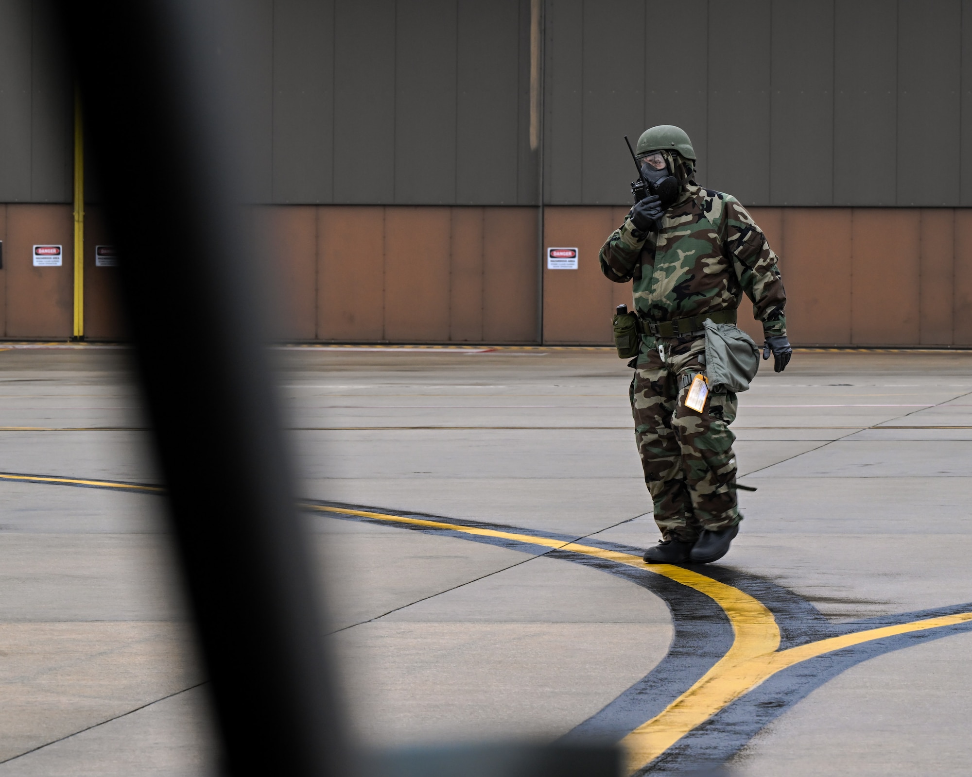 A Reserve Citizen Airman assigned to the 910th Aerial Port Squadron communicates with fellow APS Airmen while cargo is being offloaded from a C-130H Hercules aircraft during a Chemical, Biological, Radiological, Nuclear and high-yield Explosives response exercise at Youngstown Air Reserve Station, Ohio, Dec. 3, 2023.