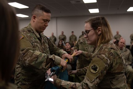 Capt. Richard Hughes and Sgt. Tianna Wilson, commander and noncommissioned officer in charge of the 161st Military History Detachment, respectively, case the unit guidon during the unit's deployment ceremony at Clay National Guard Center, Marietta, Georgia, Jan. 7, 2024. The unit will head to the Middle East to collect the history of the U.S. Army Central Command in the area.