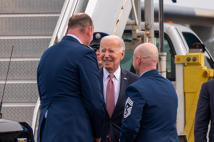 A photo of two men talking to President Biden.