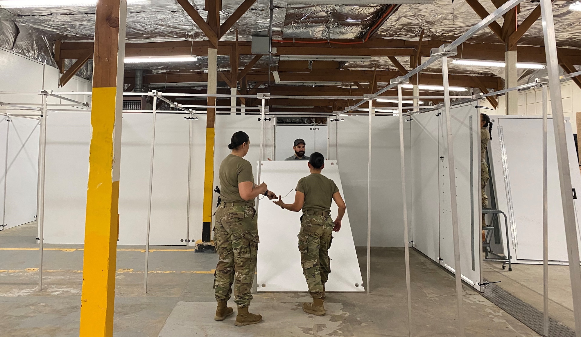 Members of the 21st Security Force Squadron construct a new shoot house at Peterson Space Force Base, Colorado, Dec. 12, 2023. The new shoot house was constructed to enhance the training capabilities for the 21st SFS and enable defenders to be better prepared for difficult real-life situations. (Courtesy photo)