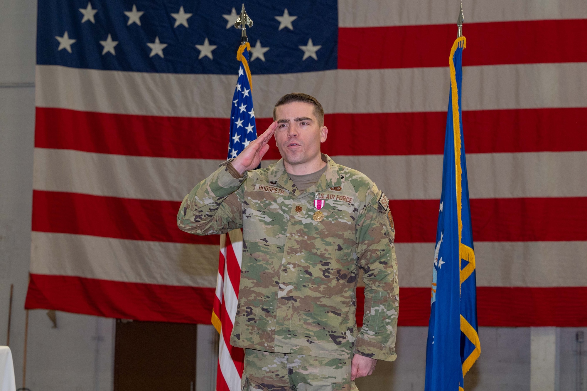 Maj. Robert Hudspeth salutes 90 MSOS Airmen.