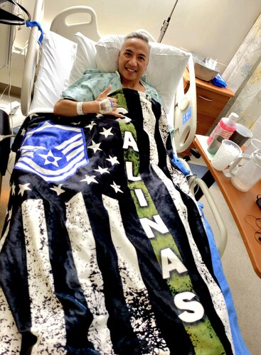Master Sgt. Manuel Salinas, a recruiter assigned to the 353rd Recruiting Squadron, March Air Reserve Base, Calif. displays a customized blanket while recovering from acute pancreatitis at UC Davis Medical Center July 9, 2022.