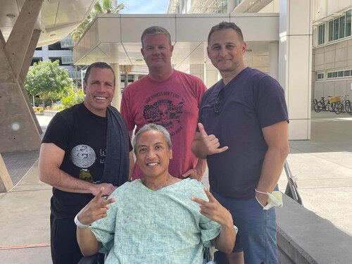 Master Sgt. Manuel Salinas, center, a recruiter assigned to the 353rd Recruiting Squadron, March Air Reserve Base, Calif. poses with fellow recruiters at UC Davis Medical Center, Sacramento, Calif. while recovering from acute pancreatitis May 20, 2022.