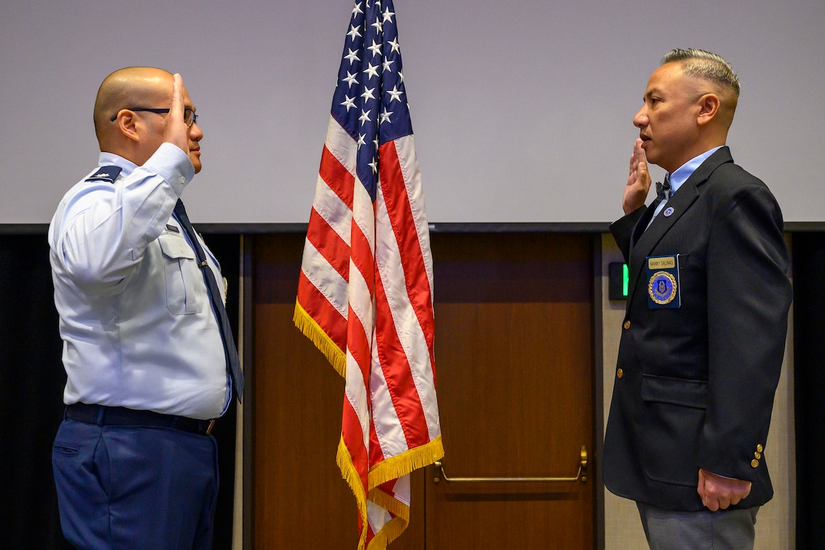 Lt. Col. Harold A. Tongson, commander of the 353rd Recruiting Squadron, March Air Reserve Base, Calif. administers the Oath of Enlistment to Master Sgt. Manuel Salinas, a recruiter assigned to the 353 RCS, Nov. 8, 2023.