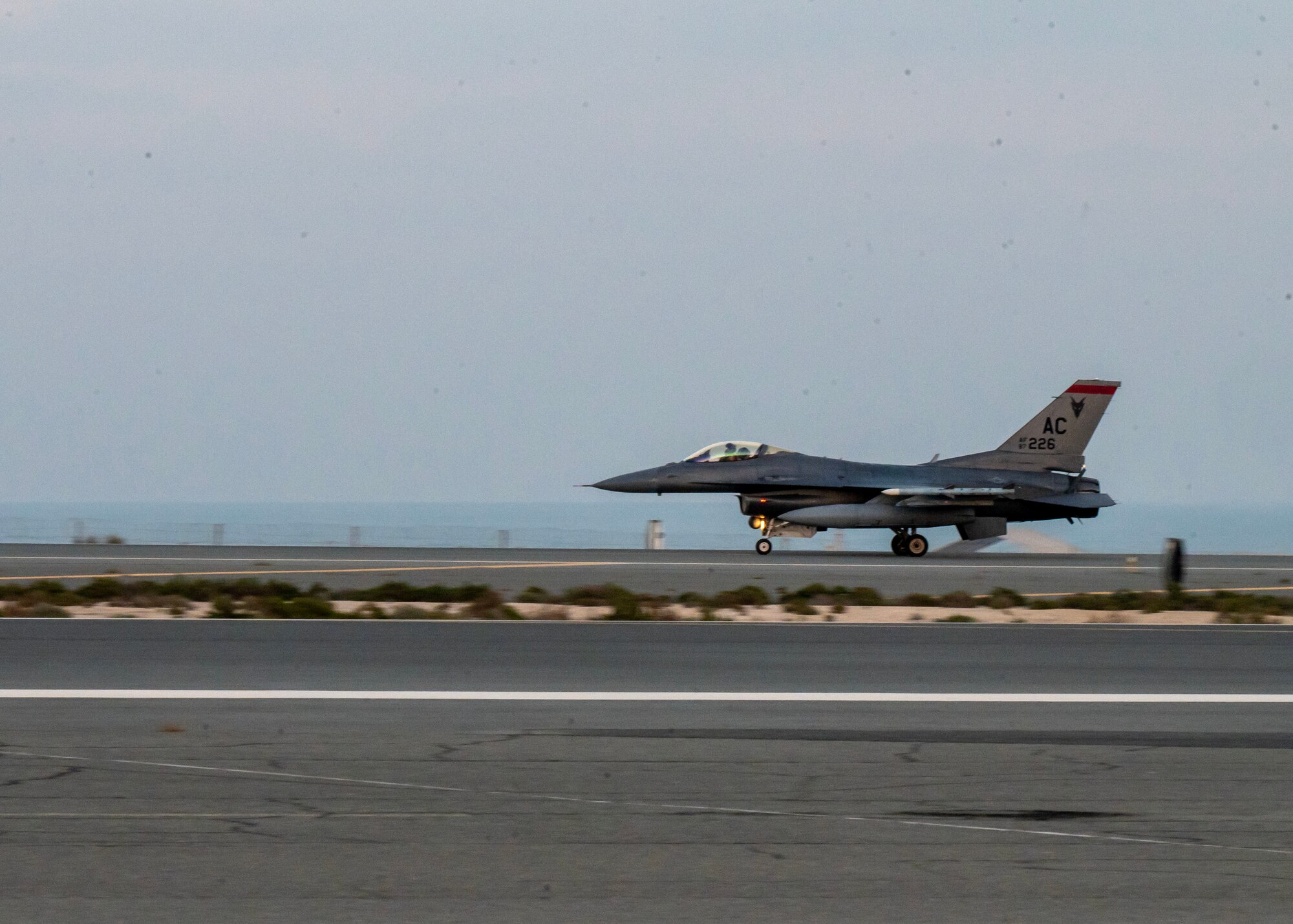 A U.S. Air Force F-16 Fighting Falcon arrives at an undisclosed location in the U.S. Central Command area of responsibility, Jan. 6, 2024. As a routine exercise Ballast Cannon occurs nearly quarterly with the Royal Bahraini Air Force to support the U.S. Air Force’s rapid expeditionary capabilities by integrating Agile Combat Employment objectives for F-16 Fighting Falcon, KC-135 Stratotanker, and operational support personnel.