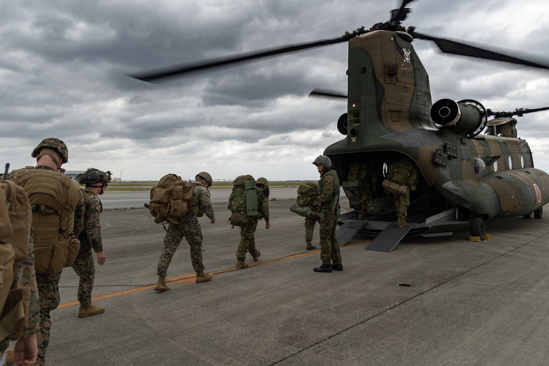 U.S. Marines with 5th Air Naval Gunfire Liaison Company, III Marine Expeditionary Force Information Group, and Japan Ground Self-Defense Force service members with Fire Leading Company, Field Artillery Battalion, Amphibious Rapid Deployment Brigade, embark a JGSDF CH-47J Chinook for joint terminal attack controller training at Naha Air Base, Okinawa Japan, Nov. 13, 2023. The training tested U.S. and Japanese service members’ ability to enhance and sustain tactics and procedures for terminal control of fires. 5th ANGLICO provides the Marine Air Ground Task Force Commander with a liaison capability to plan, coordinate, employ, and conduct terminal control of fires in support of joint, allied, and coalition forces. (U.S. Marine Corps photo by Cpl. William Wallace)
