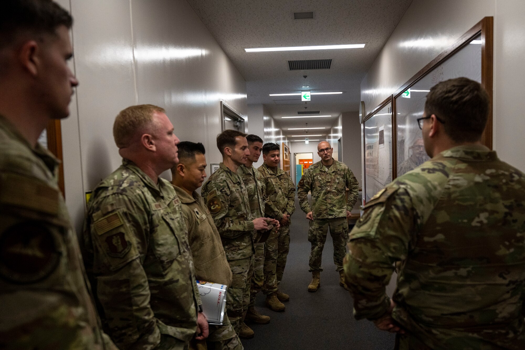 Members of the 35th Civil Engineering Squadron electrical systems flight explain power outage procedures using maps during a Wild Weasel Walk-through at Misawa Air Base, Japan.