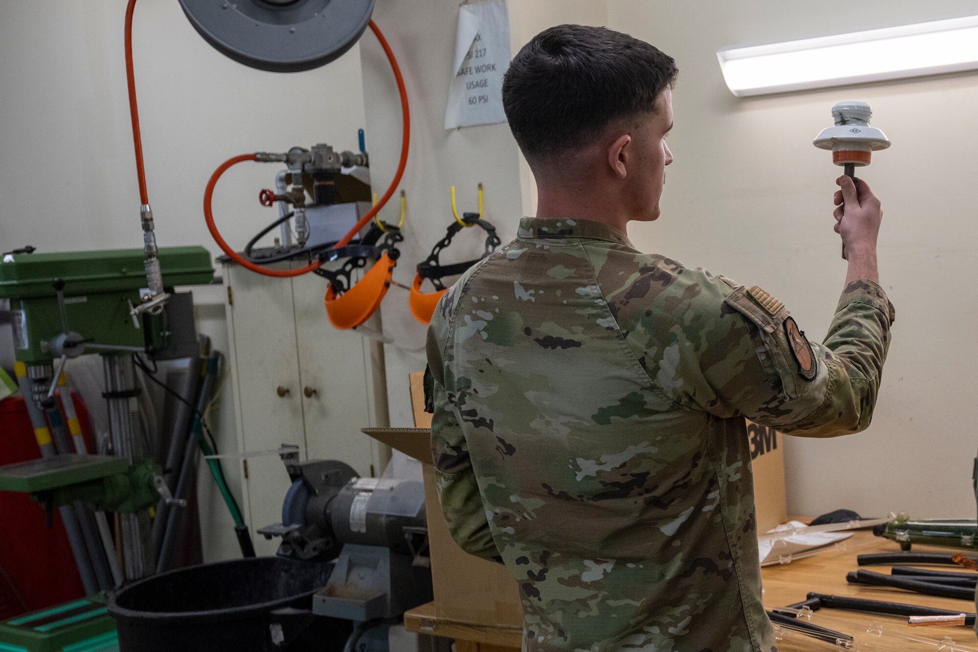 U.S. Air Force Airman 1st Class Cole Grim, 35th Civil Engineering Squadron electrical systems apprentice, demonstrates the equipment repair process during a Wild Weasel Walk-through at Misawa Air Base, Japan.