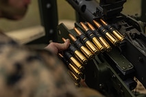 U.S. Marine Corps Cpl. Zachary Posey, left a heavy equipment mechanic with 3rd Maintenance Battalion, 3rd Marine Logistics Group, reloads a M2 Browning .50 Caliber machine gun at Camp Hansen, Okinawa, Japan, Dec. 22, 2023. The reason for the training was to increase their lethality, survivability, and capability when it comes to employing the M2 .50 Caliber machine gun in a mounted platform. (U.S. Marine Corps photo by Lance Cpl. Weston Brown)
