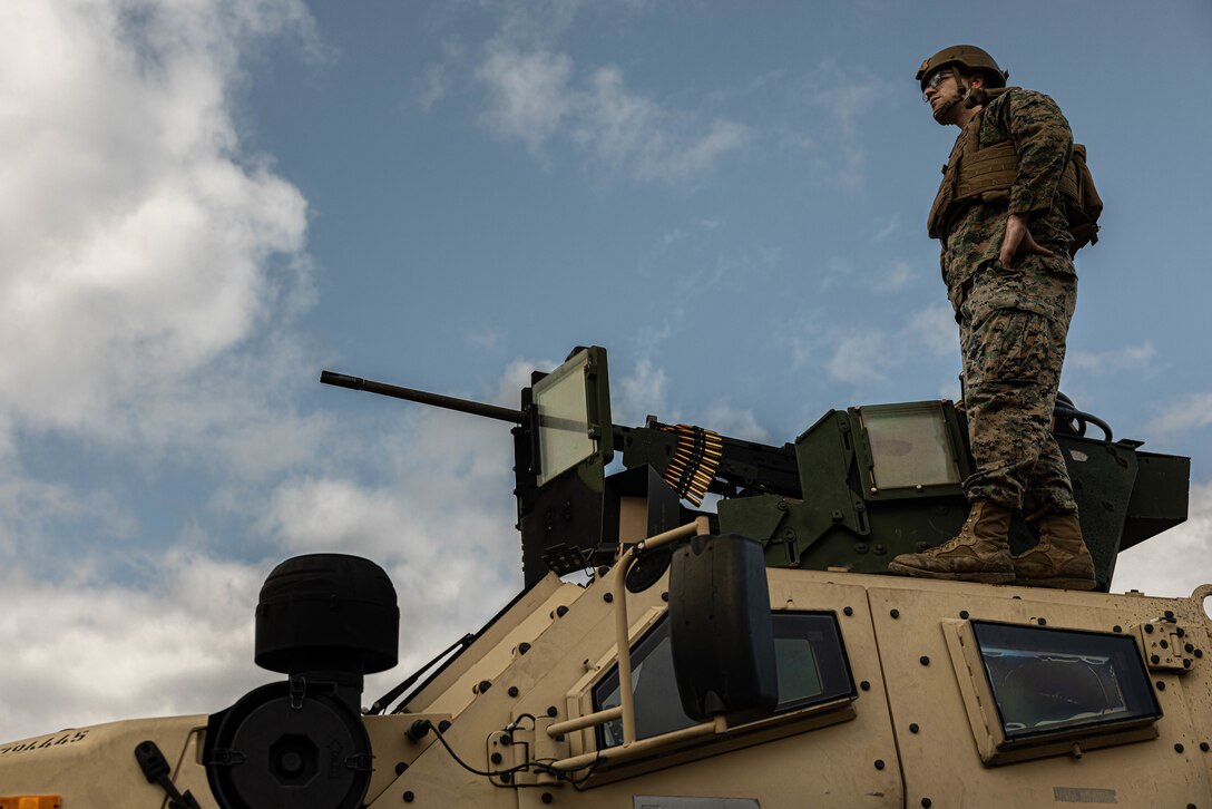 U.S. Marine Corps Noah Bowels, an engineer equipment mechanic with 3rd Maintenance Battalion, 3rd Marine Logistics Group, stands on top of a Joint Light Tactical Vehicle at Camp Hansen, Okinawa, Japan, Dec. 22, 2023. The reason for the training was to increase their lethality, survivability, and capability when it comes to employing the M2 .50 Caliber machine gun in a mounted platform. (U.S. Marine Corps photo by Lance Cpl. Weston Brown)